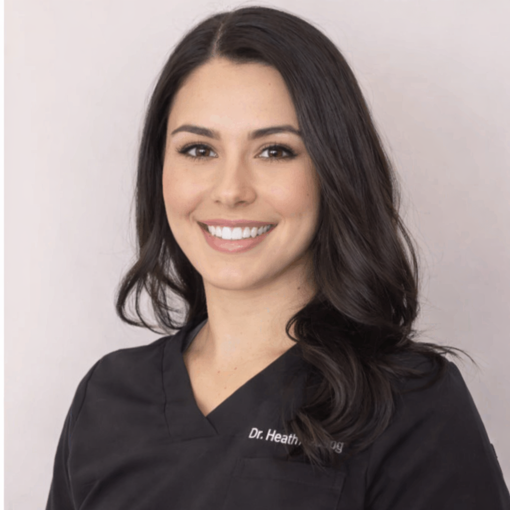 Dr. Heather Heim-board certified chiropractor-smiling in professional attire