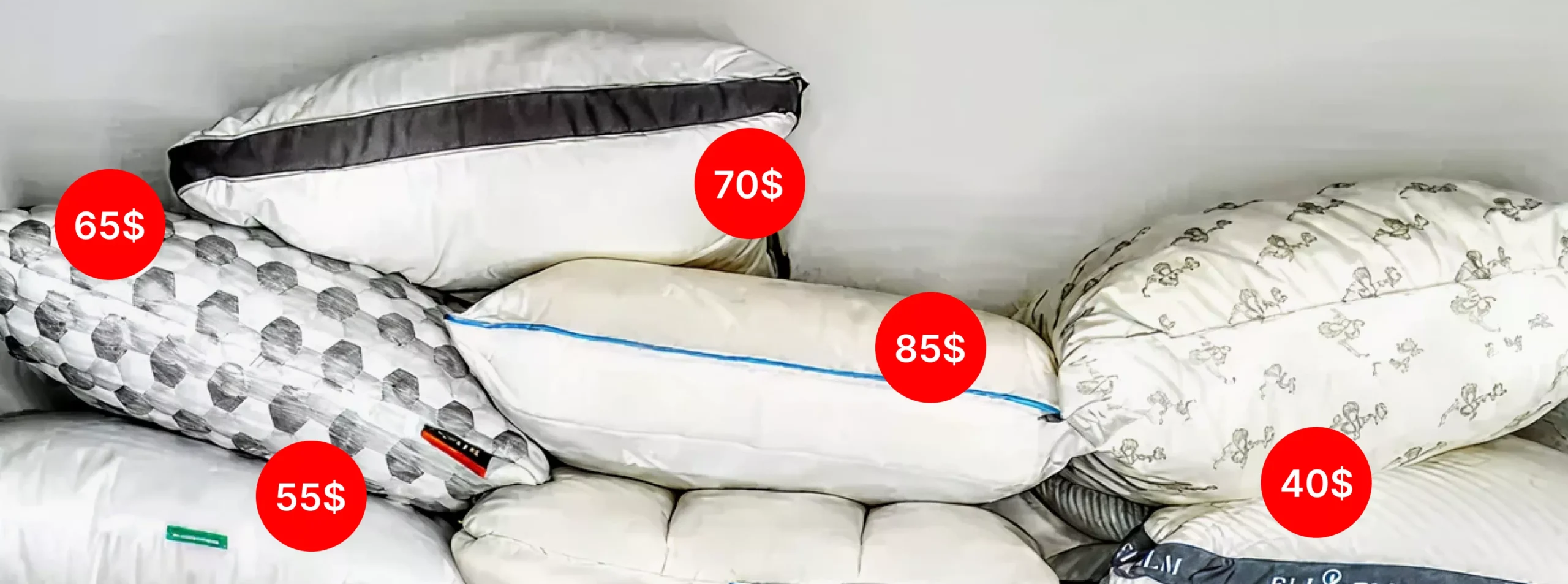 Various pillows stacked with price tags-65$, 70$, 85$, 55$, 40$-showcasing different pillow styles